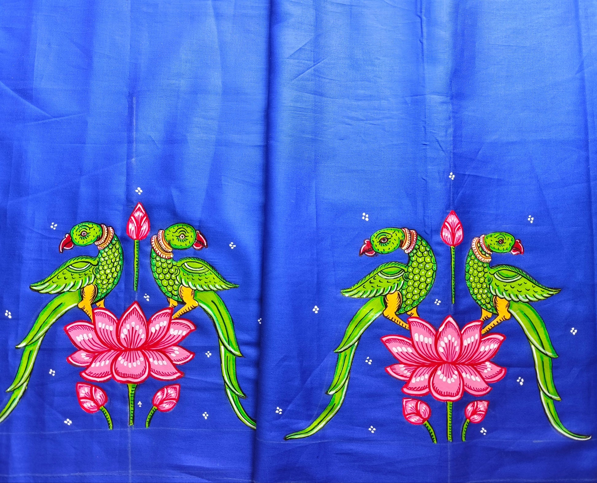 Embroidered fabric with parrots and lotus flowers on a blue background