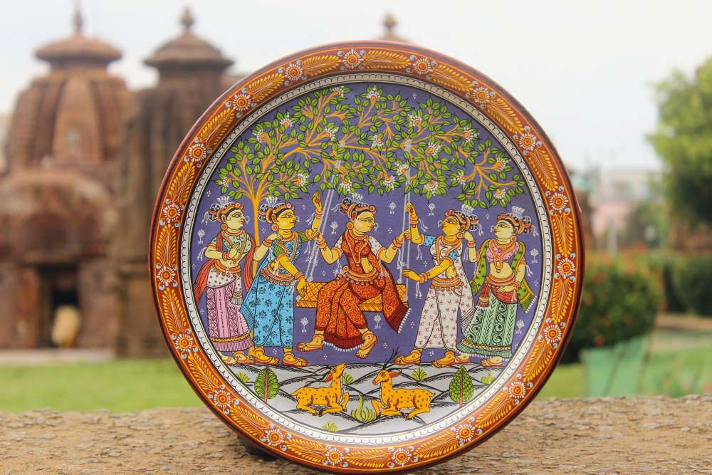 Hand-painted Pattachitra Radha In Jhoola With Gopis Wall Plate by Maavni